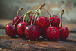 A cluster of cherries, glistening with dewdrops, is nestled on a rustic wooden surface