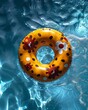 Top view of colorful swim rings on the blue water background.