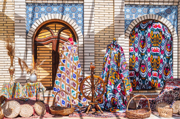 Poster - bright multicolored silk fabrics for dresses at the oriental bazaar in Uzbekistan in Tashkent