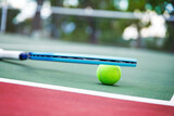 Fototapeta Zachód słońca - Tennis racket and ball on the court. Close-up.
