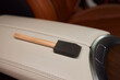 Wooden brush rests on leather car door