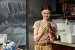 Woman holding lizard in hand in front of kitchen domestic pet interaction concept photo