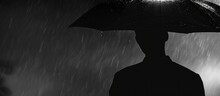 Silhouette Of A Man Carrying An Umbrella During Heavy Rain