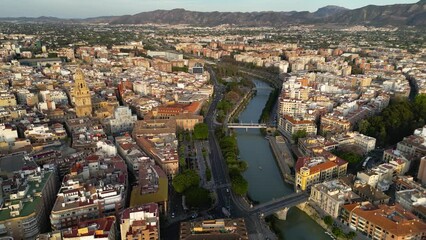 Wall Mural - Cinematic aerial view of medieval city of Murcia. View of all city center. At left is the Cathedral of Murcia in the middle is River Segura. Panoramic view of all region