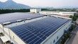 © Stavros's son - Solar panels installed on a roof of a large warehouse or industrial building.
