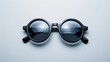 Fashionable sunglass meticulously positioned in a symmetrical layout, top view on an immaculate white backdrop