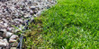 Gravel and lawn in home garden. Gardening concept background. Lawn edge close up summer