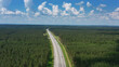 Aerial top view on country road in forest