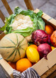 A box of vegetables and fruits outdoors near a street shop, real photo. High quality photo