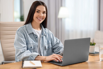 Poster - Young woman watching webinar at table in room