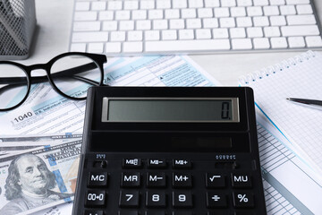 Wall Mural - Tax accounting. Calculator, documents, money, stationery and glasses on light grey table, closeup