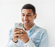 Portrait of young African American man holding mobile phone standing on a white background