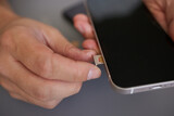 Fototapeta Kwiaty - SIM card replacement in the phone