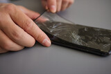 Fototapeta  - replacing broken glass with a new one. Broken smartphone display. Broken glass phone. Smartphone repair