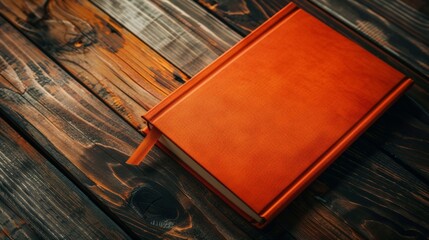 Poster - orange book on wooden surface