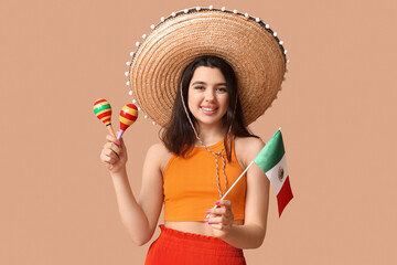 Sticker - Beautiful young happy woman in sombrero with Mexican flag and maracas on beige background. Cinco de Mayo celebration