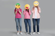 © New Africa - People covering faces with emoticons on grey background