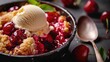 Vanilla ice cream on warm cherry cobbler in bowl with spoon