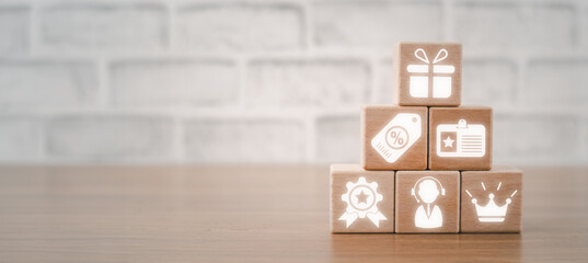 Loyalty program concept, Wooden block on desk with loyalty program icon on virtual screen.