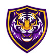 powerful Bengal tiger with a raised head, roaring in front of a purple LSU shield