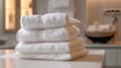 A stack of clean white towels waiting to be used in the sauna and massage rooms ensuring a hygienic and luxurious experience..