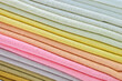 stack of colourful cotton clothes, close up pile of clothing