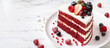 Red Velvet cake with a bright white cream texture, adorned with fresh berries. Holiday desserts. Banner, copy space