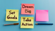 © AiDesign - dream big , set goals, take action on sticky notes isolated blue background