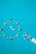 Clock made from colorful pills as a concept of taking medicine in time, by prescription.