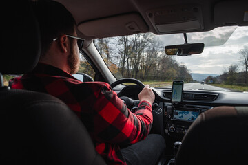 Poster - road trip concept man driving car by highway inside view