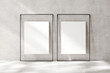 Two blank vertical frames leaning against a wall with sunlight casting soft shadows in a minimalistic setup Perfect for art mockups or gallery display, 3d render.