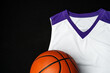 Close-Up of Basketball and White and Purple Jersey on a Black Background