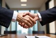 Two business people shake hands, symbolizing mutual agreement and trust in their partnership or deal
