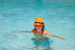 Kid boy relaxing in pool. Child swimming in water pool. Summer kids activity, watersports.