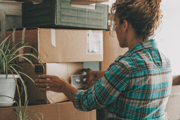 Independent lifestyle female people relocating house moving boxes cardboard. New home owner lifestyle. Real life event for change. Beginnings. Woman working indoor leisure activity. Freedom concept