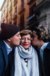 © Westend61 - Men kissing mother in front of building