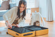 Happy Backpacker travel of journey, asian young woman with her Scottish fold cat pet while check list packing or prepare clothes into luggage suitcase, holiday vacation of traveler.