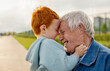 © Westend61 - Happy senior man having fun with redhead grandson at park