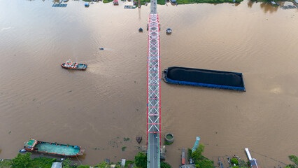 Wall Mural - aerial view of a coal barge passing through a South Kalimantan river