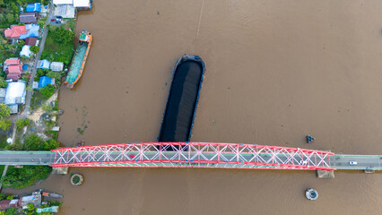 Wall Mural - aerial view of a coal barge passing through a South Kalimantan river