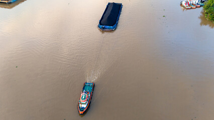 Wall Mural - aerial view of a coal barge passing through a South Kalimantan river