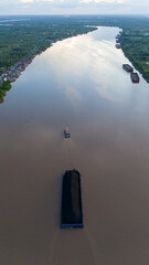 Wall Mural - aerial view of a coal barge passing through a South Kalimantan river