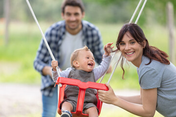 father and mum play with his toddler