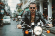 Motorcycle, travel and journey with man in city for freedom, driving and vintage.