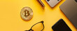 Modern Workplace with Bitcoin Token Next to Yellow Accessories