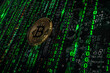 Golden Bitcoin Coin against a Backdrop of Streaming Green Matrix Code