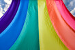 Fabric rainbow flag fluttering and going to sky. LGBT pride concept. pride month celebrates the festival background.