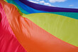 Fabric rainbow flag fluttering and going to sky. LGBT pride concept. pride month celebrates the festival background.