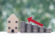 Mortgage,Model house and stack of coins money on natural green background,Business investment and real estate concept