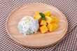 Sticky rice with mango on wood plate